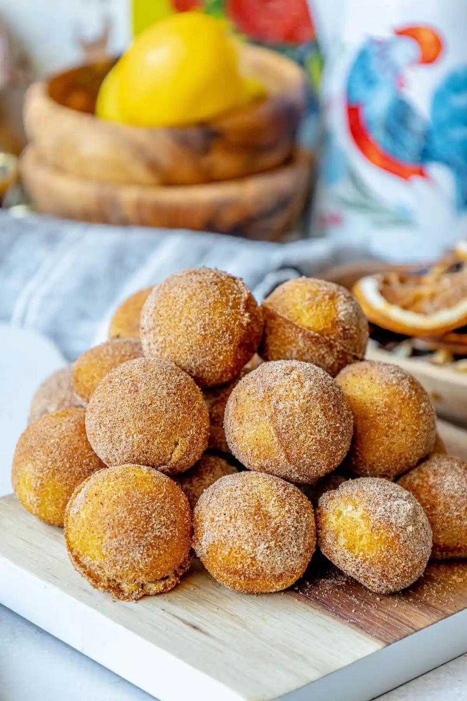 A stack of 10 minute cinnamon sugar donuts on a cutting board.