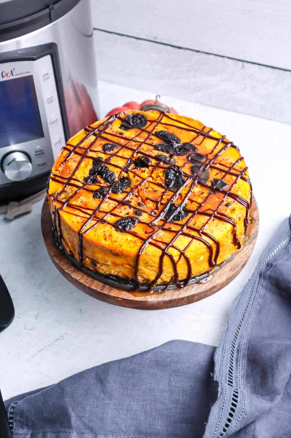 picture of a pumpkin oreo cheesecake next to an instant pot