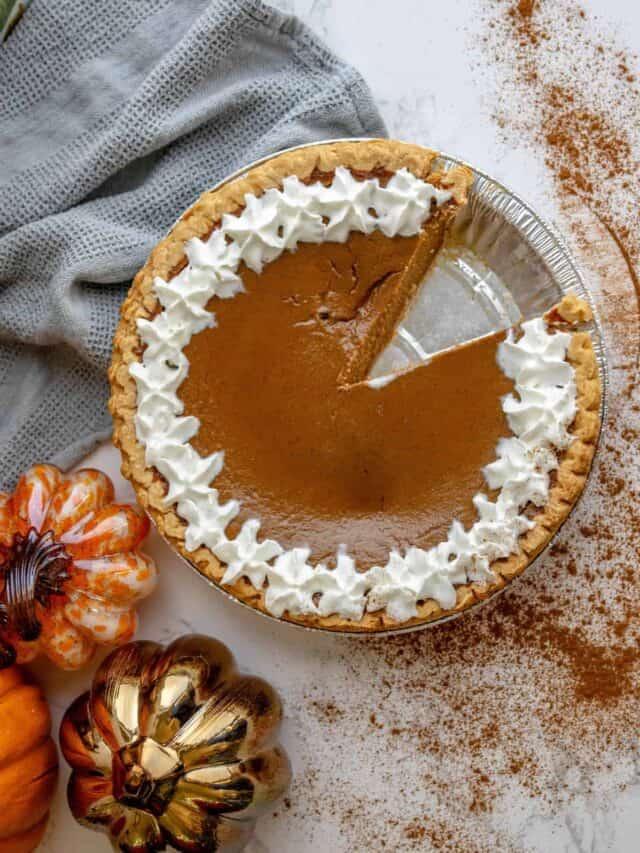 A slice of pumpkin pie with whipped cream.