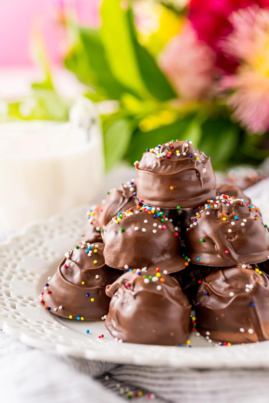 Chocolate covered donuts on a white plate.