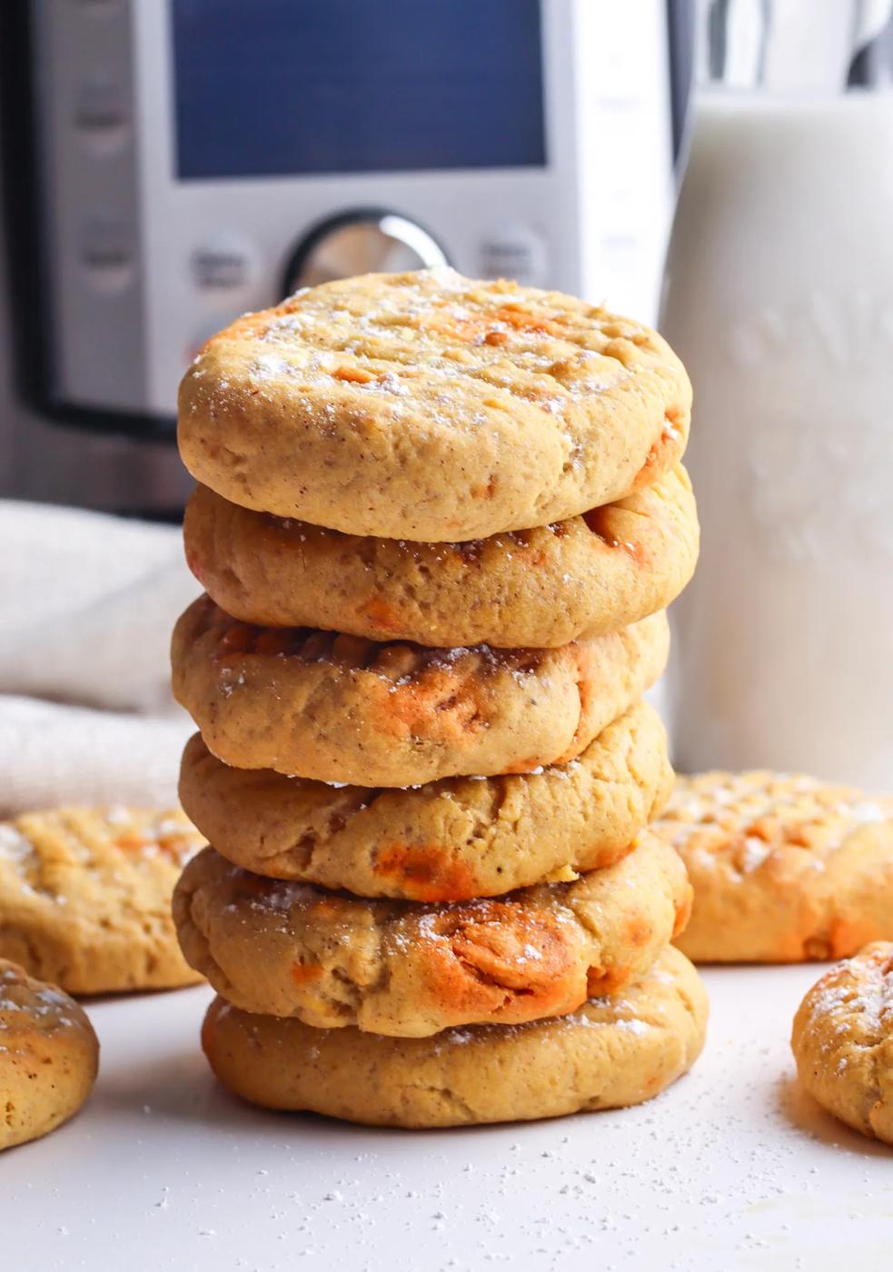 A stack of air fryer cookies in front of a milk machine.