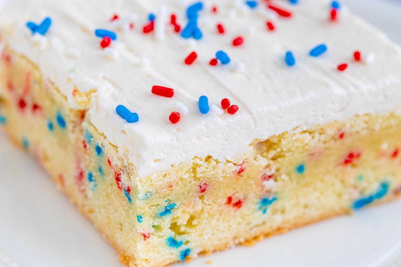 a vanilla bar with red and blue sprinkles in them and on frosting on top