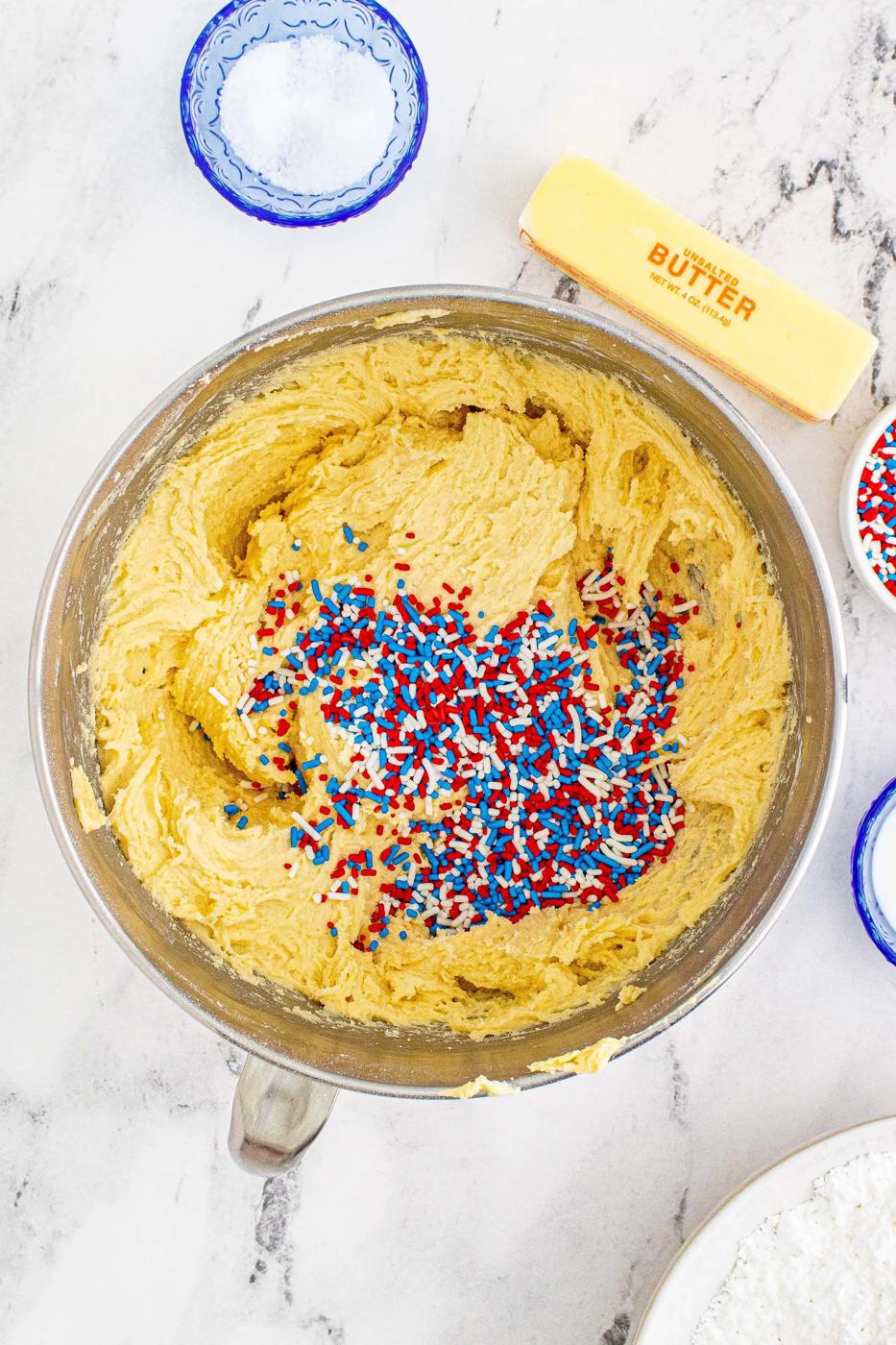 cake batter in a bowl with sprinkles in it