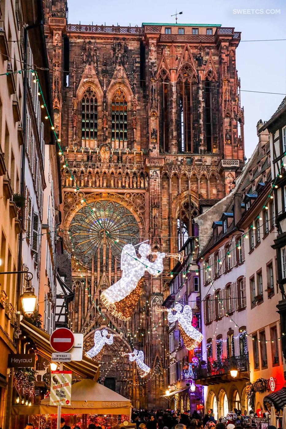 A picturesque Christmas market in Strasbourg, France with a stunning cathedral backdrop.