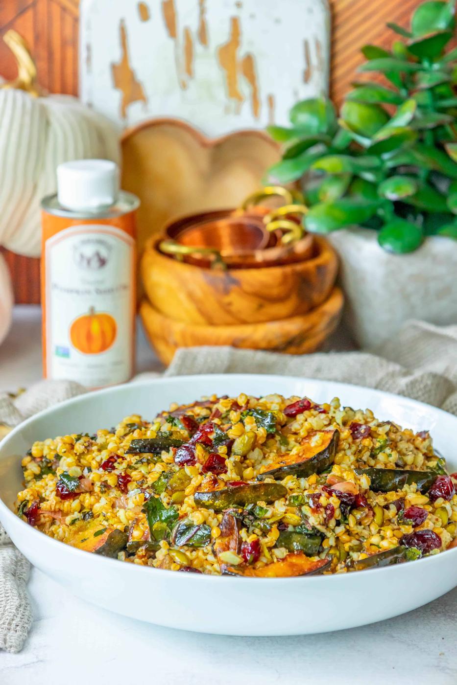 A bowl of food with cranberries and pumpkins in it.