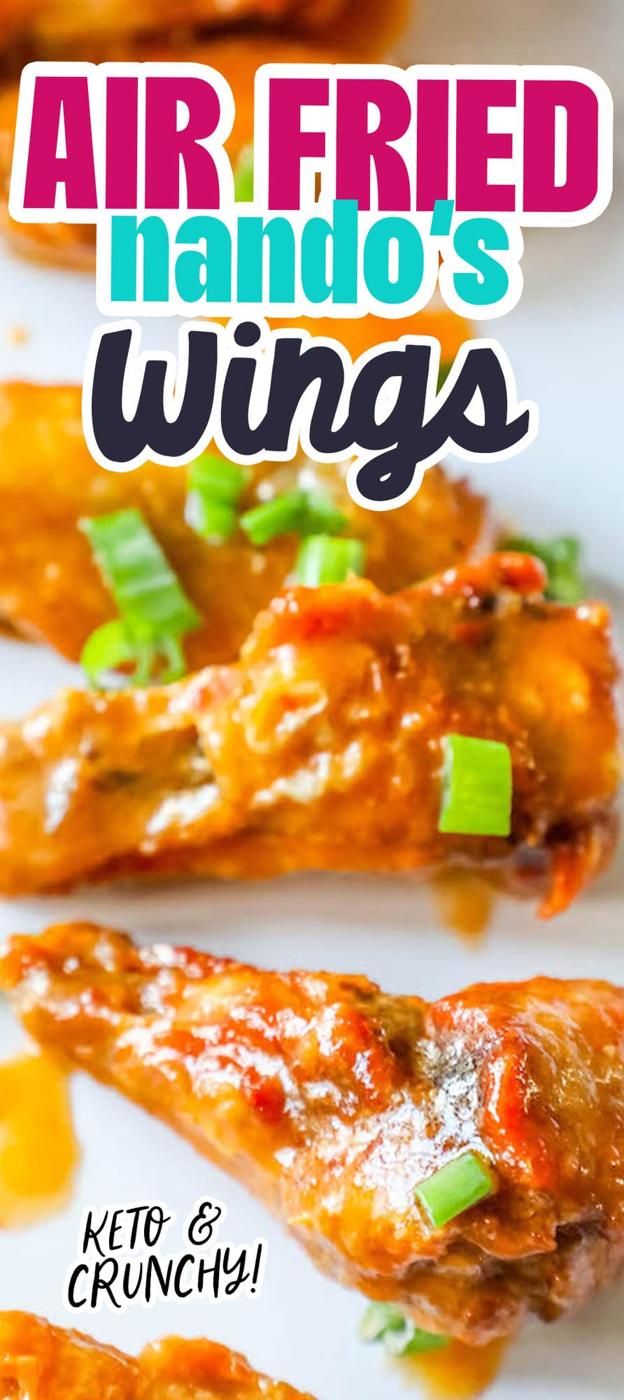 chicken wings in sauce on a white plate with chopped green onions