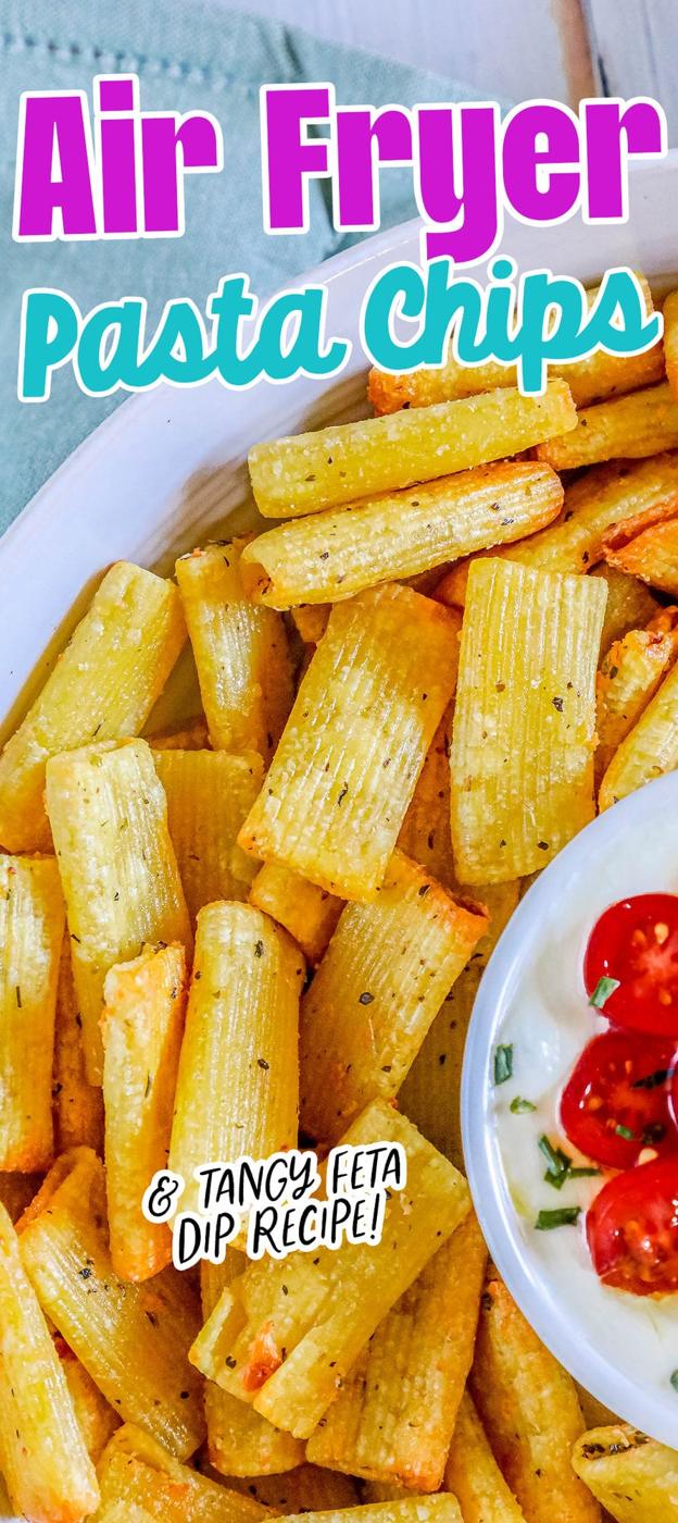 picture of air fried pasta chips in a bowl with feta dip with tomatoes sliced on top