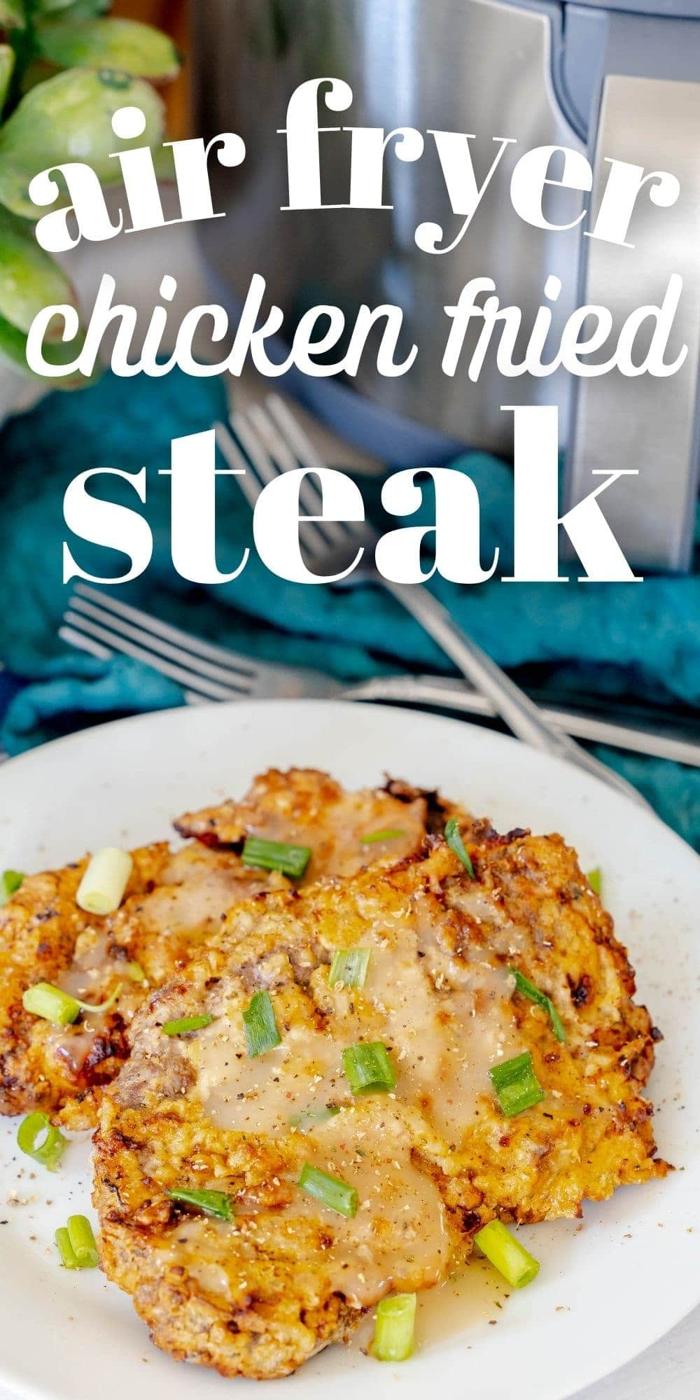 breaded chicken fried steak on a white plate in front of an air fryer