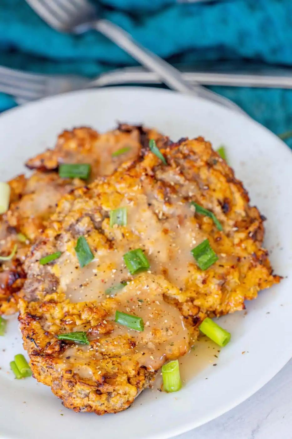 A plate with air fried chicken fried steaks.