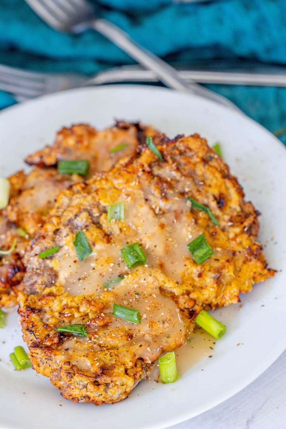 A plate with air fried chicken fried steaks.