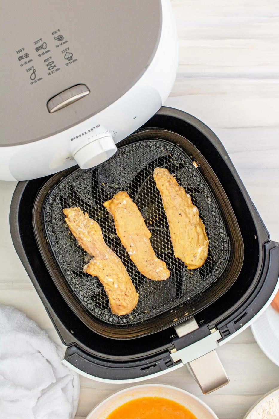 A Philips Airfryer is utilized for preparing food.