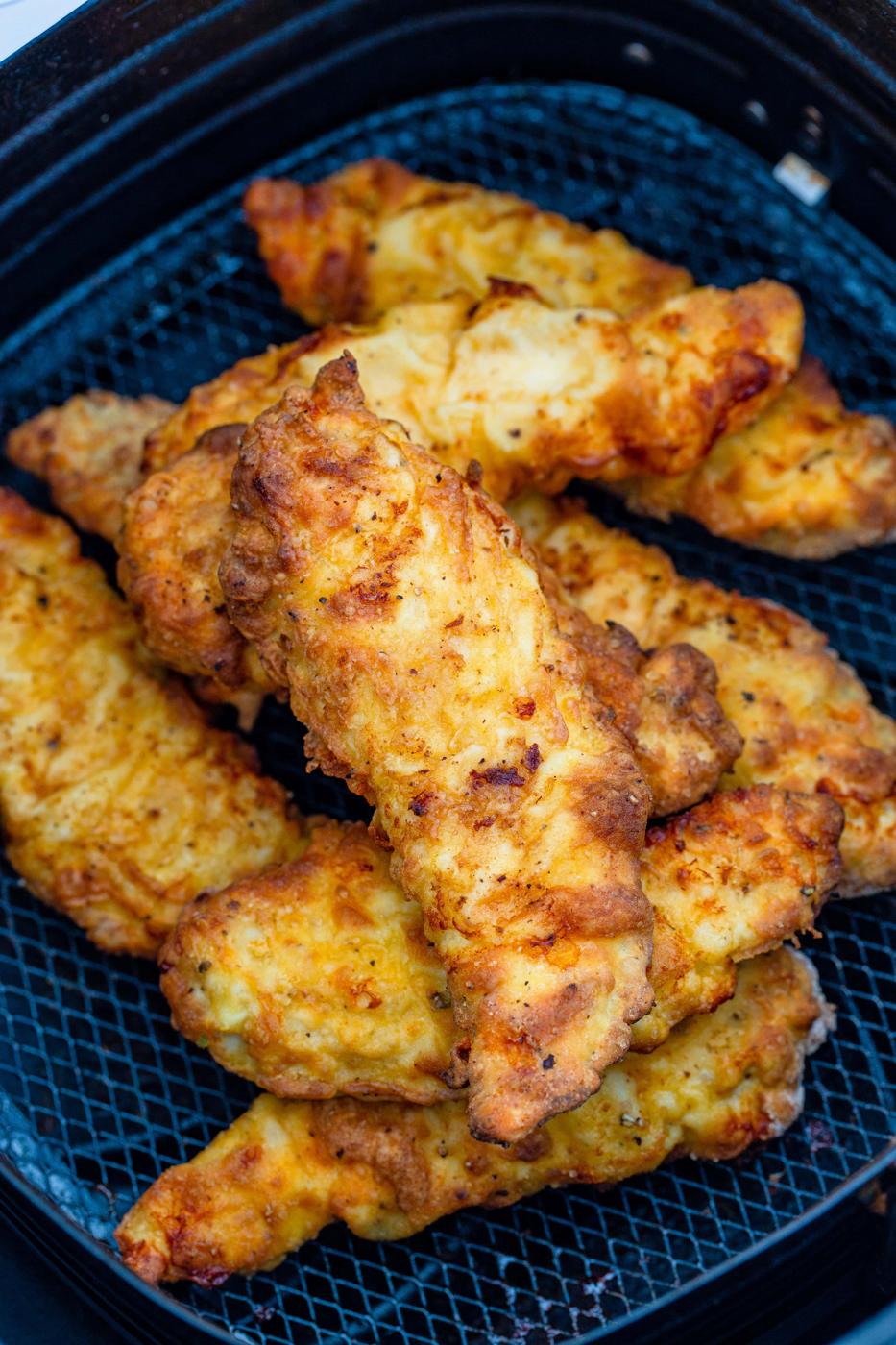 chicken tenders in a fryer basket