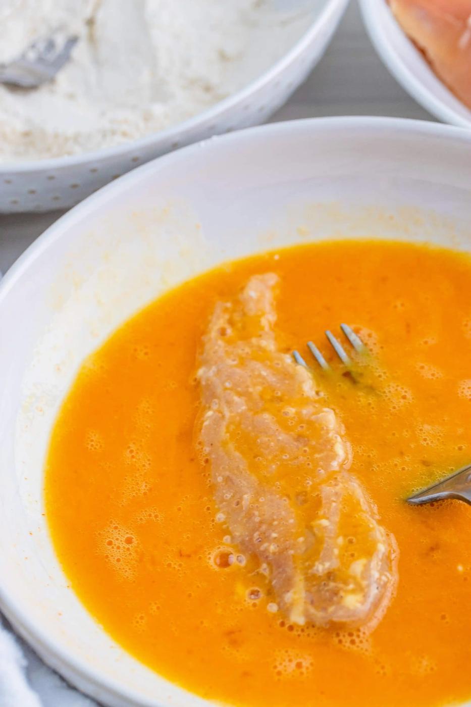 A bowl of soup with a fork in it.