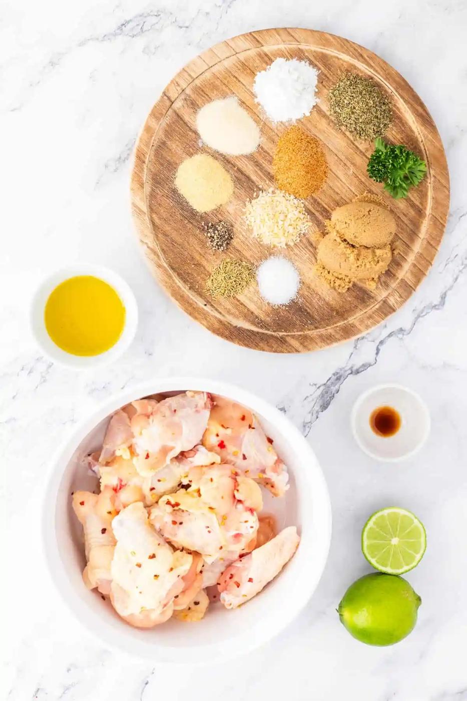 A delectable bowl of air fryer chicken wings, enhanced with flavorful spices and ingredients, placed elegantly on a stylish marble table.