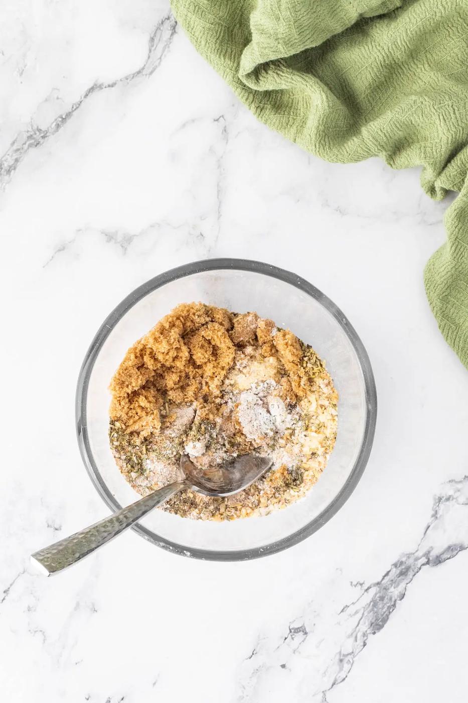 A bowl of oatmeal with a spoon on a marble table, next to an air fryer.