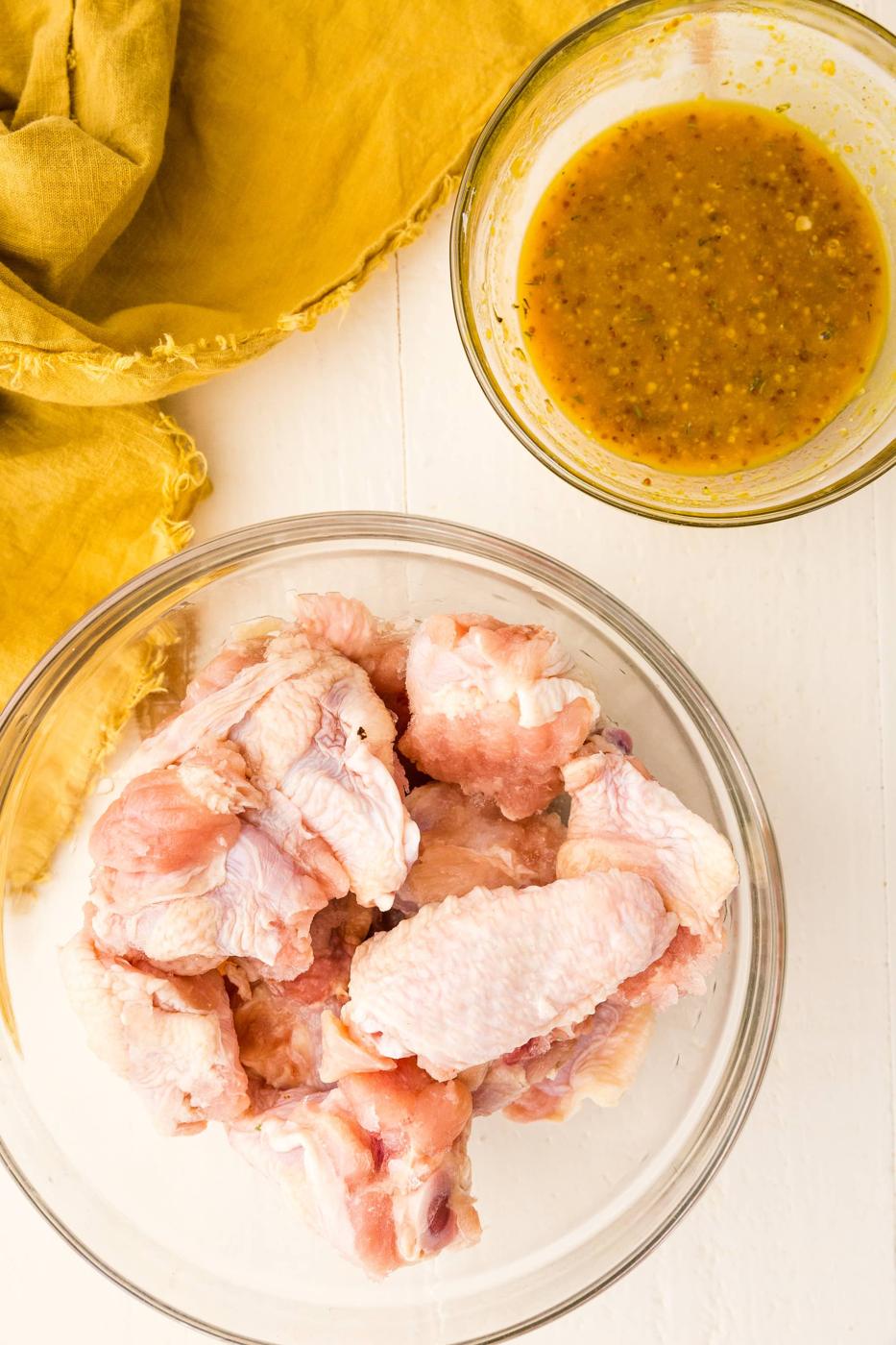 wings in a bowl, sauce in a bowl