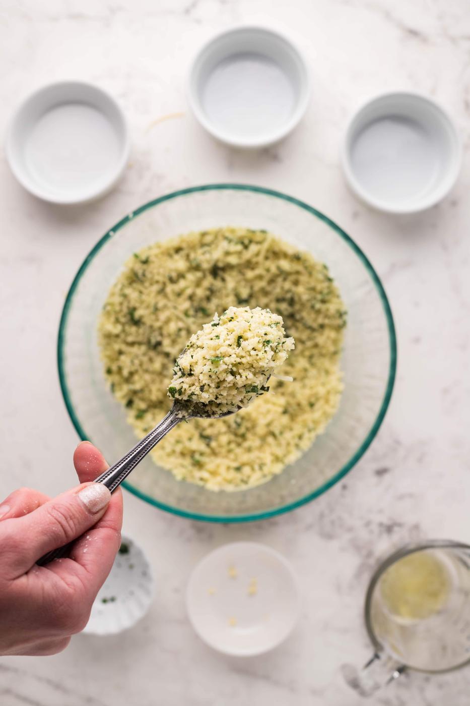 A person pouring parmesan crusted steak into a bowl.