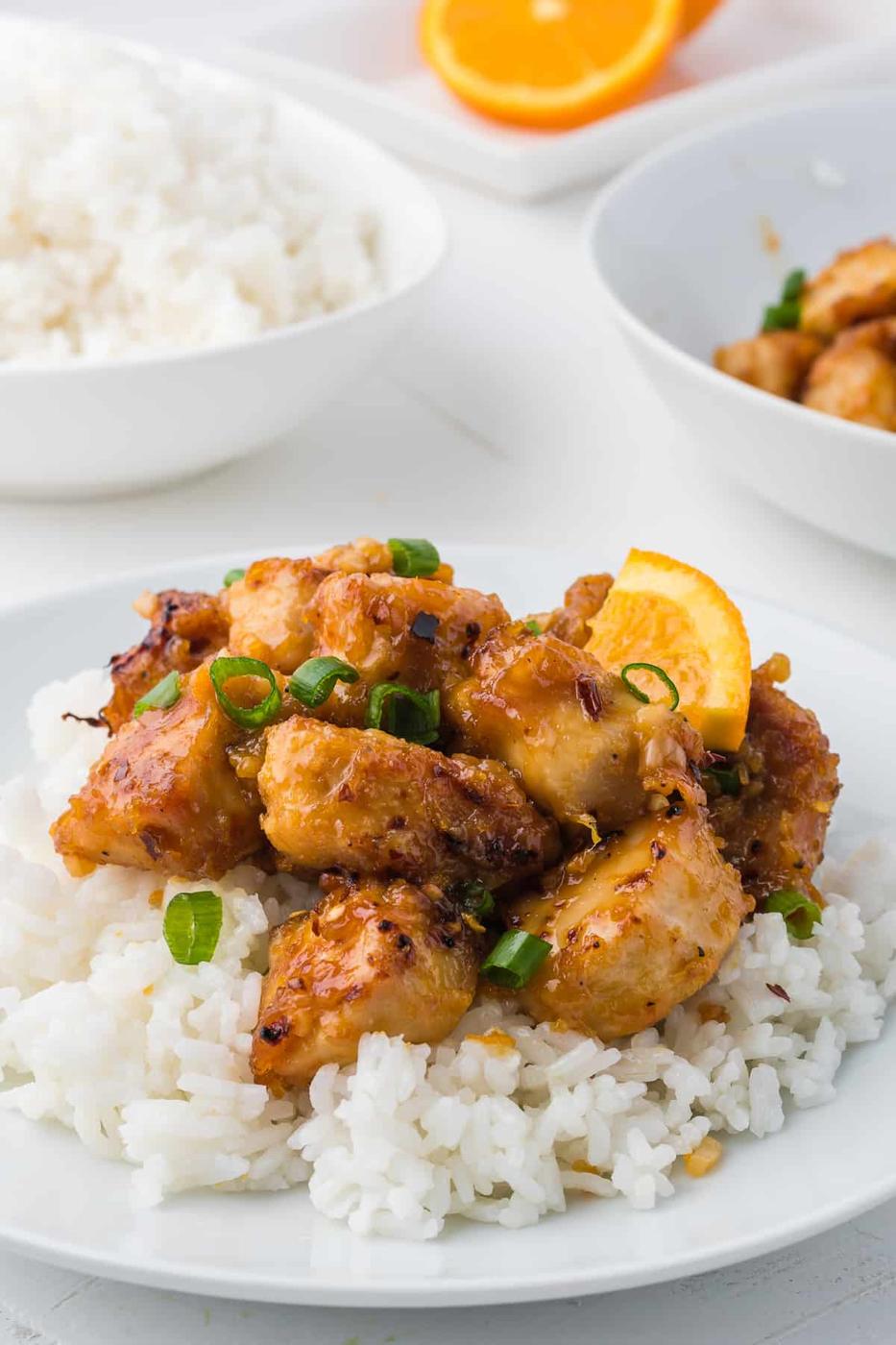 A plate of Orange Chicken with rice.