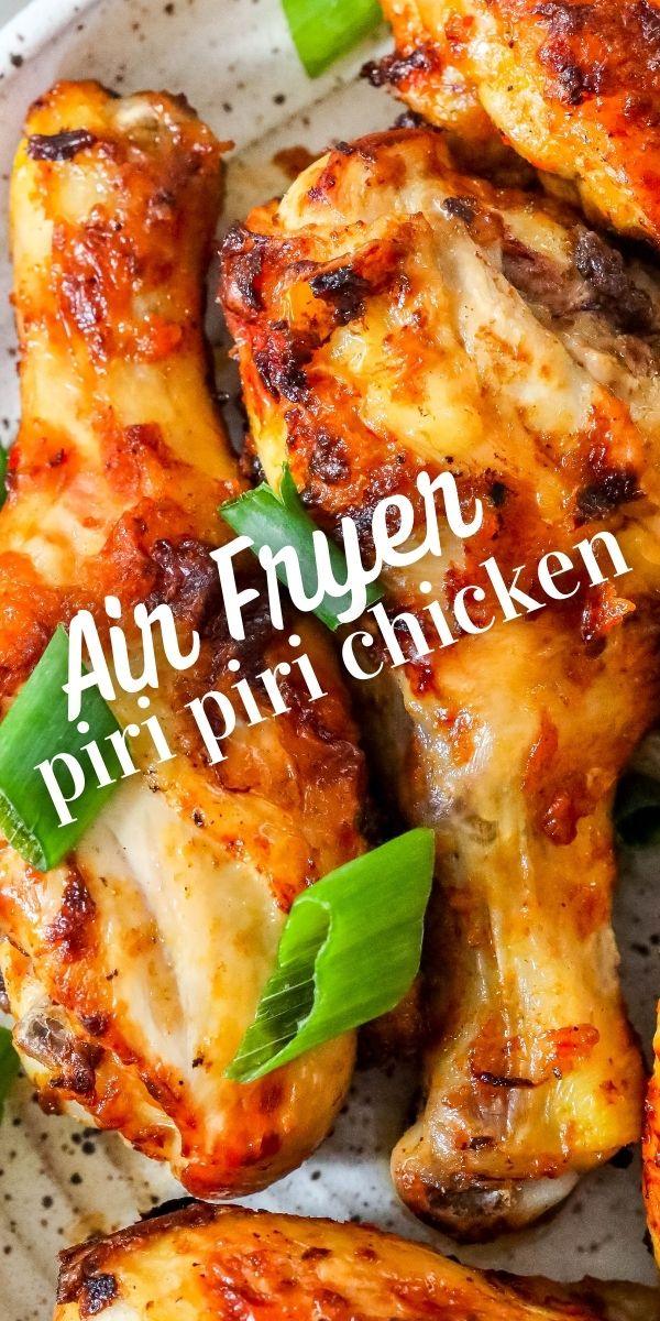 picture of spiced chicken drumsticks with green onions on it.