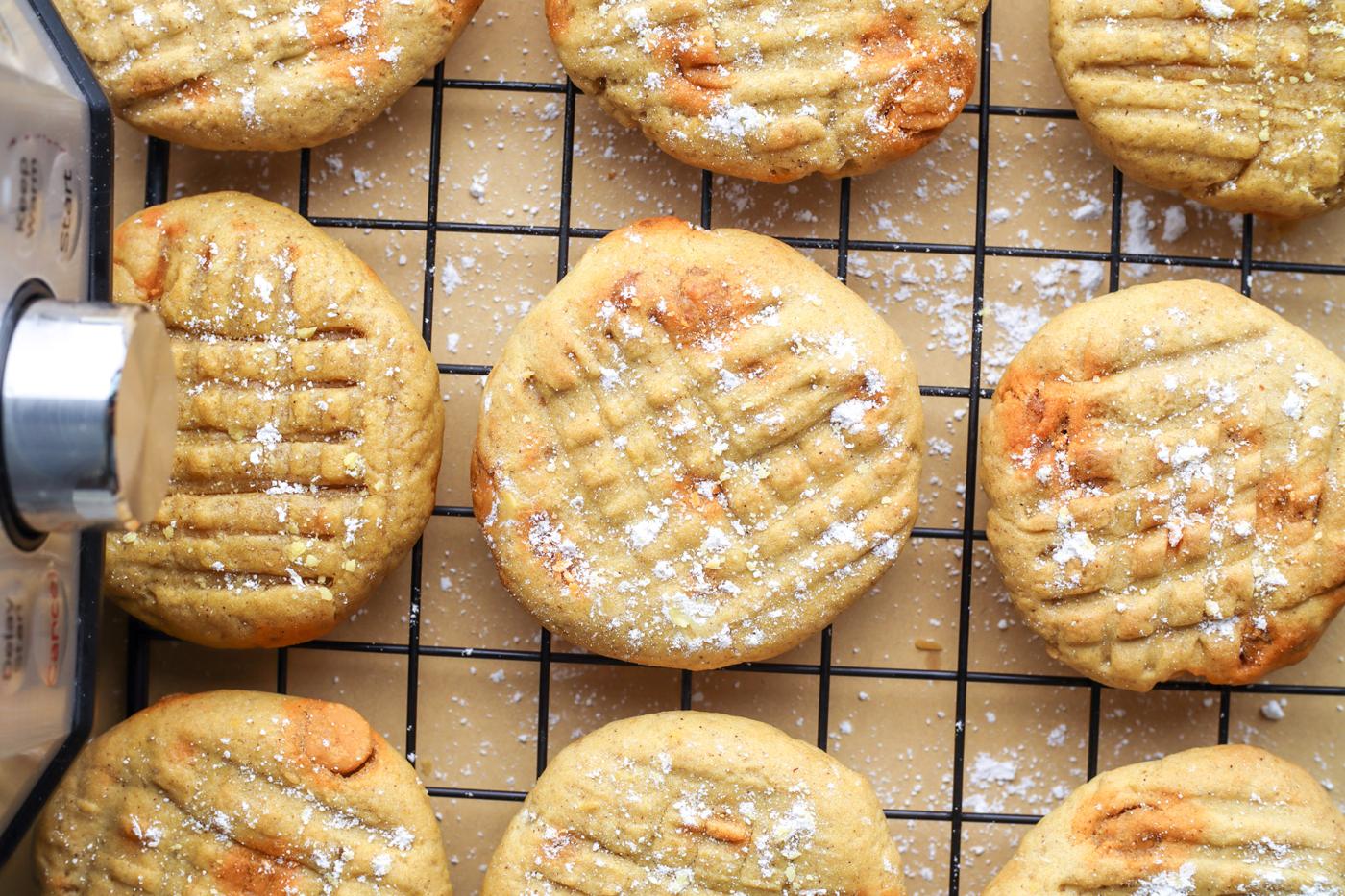 picture of pumpkin cookies with butterscotch chips on a cooling rack next to an air fryer
