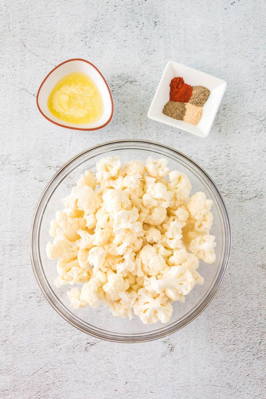 cauliflower, melted butter, spices on a table