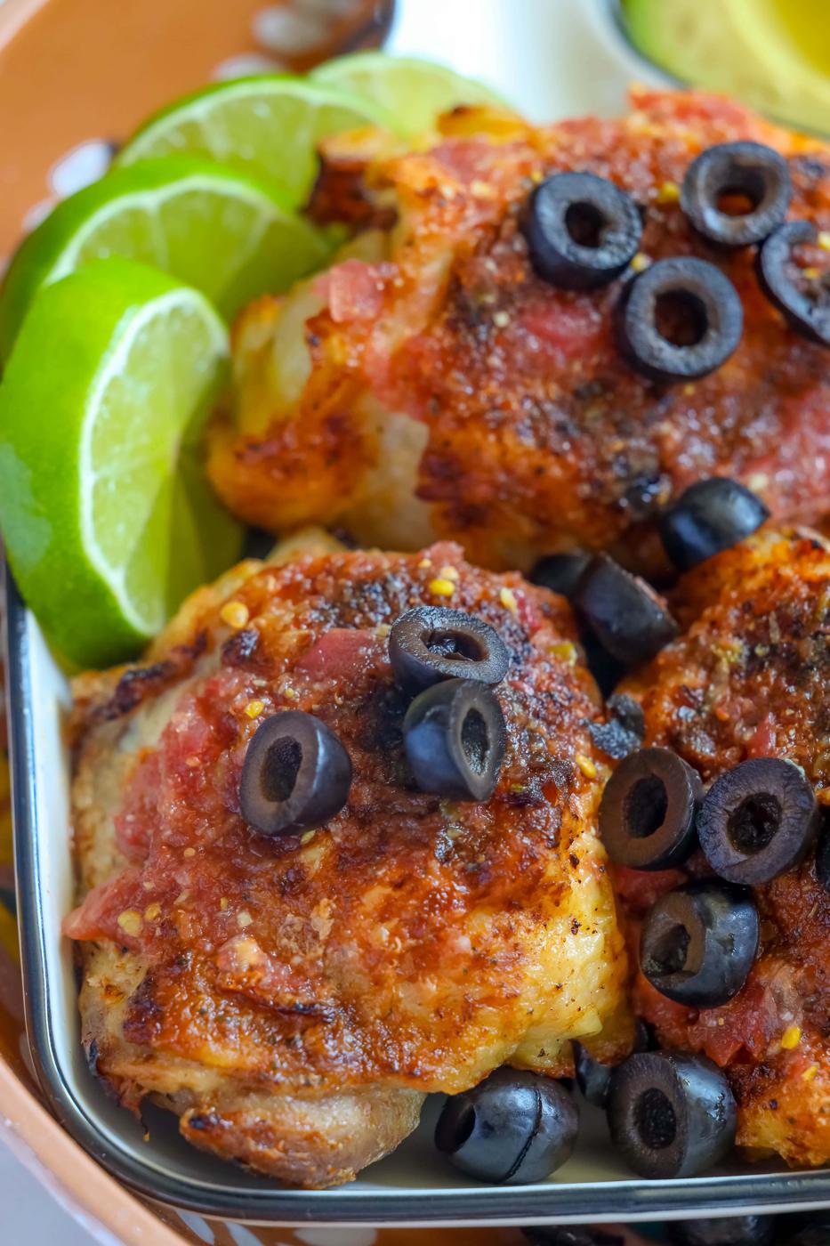 Air fried chicken with olives and lime on a plate.