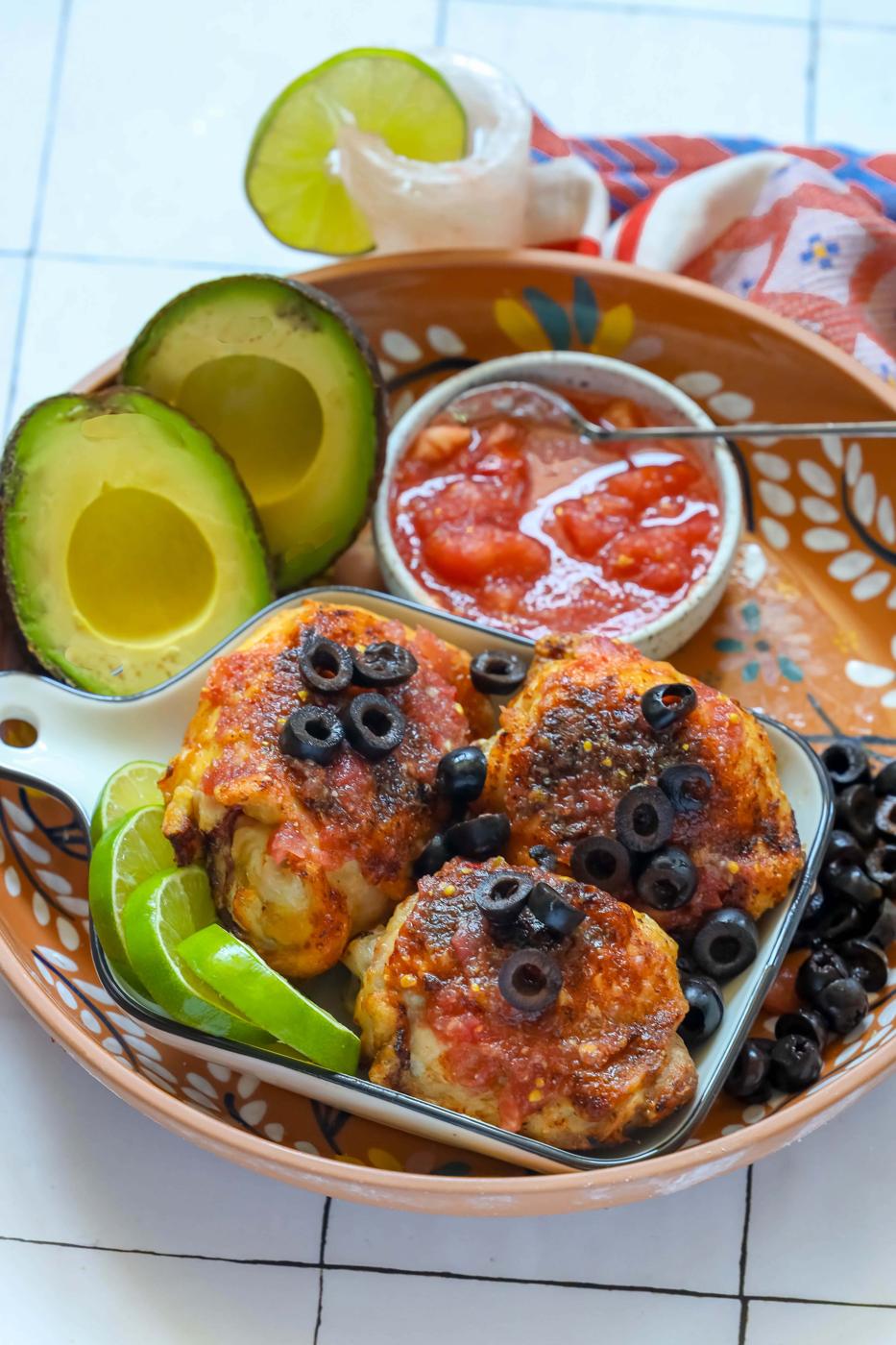 Mexican chicken enchiladas with air-fried salsa chicken thighs served alongside guacamole and salsa.