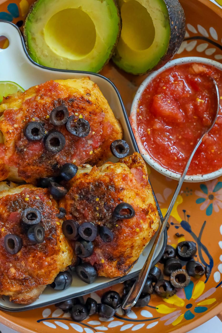 Mexican chicken enchiladas with air fryer salsa chicken thighs and fresh tomatoes and avocados.