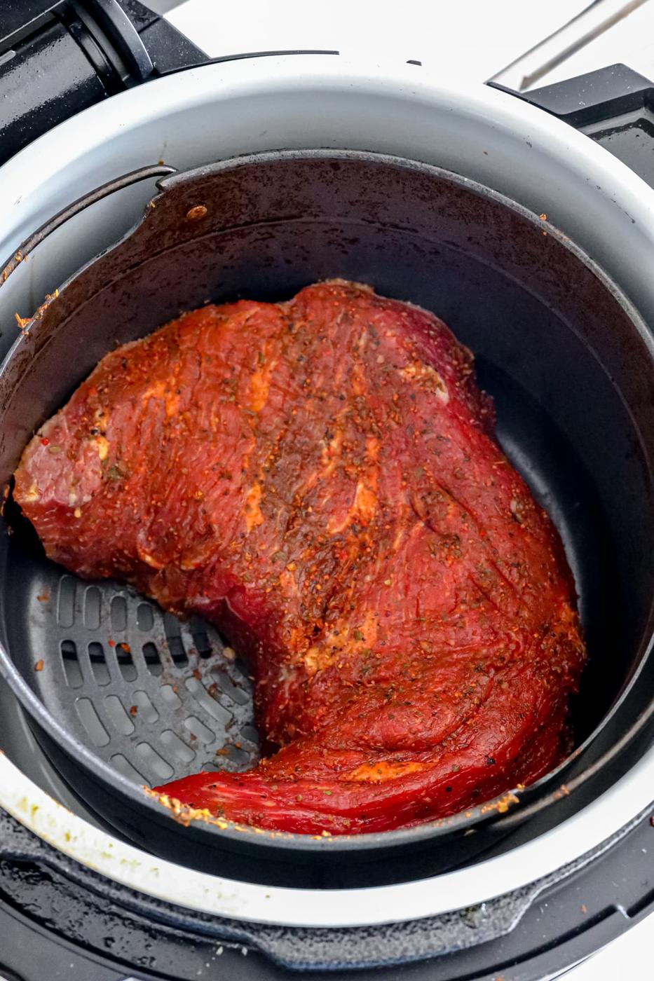 picture of tri tip steak in an air fryer basket