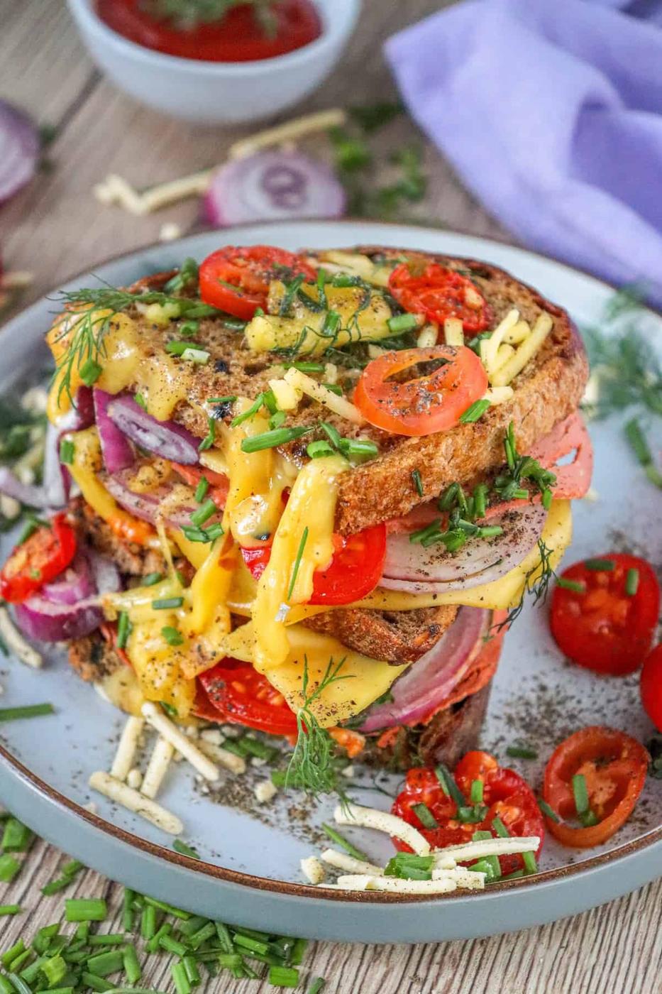 A vegan sandwich with tomatoes and onions, perfect for a quick meal.
