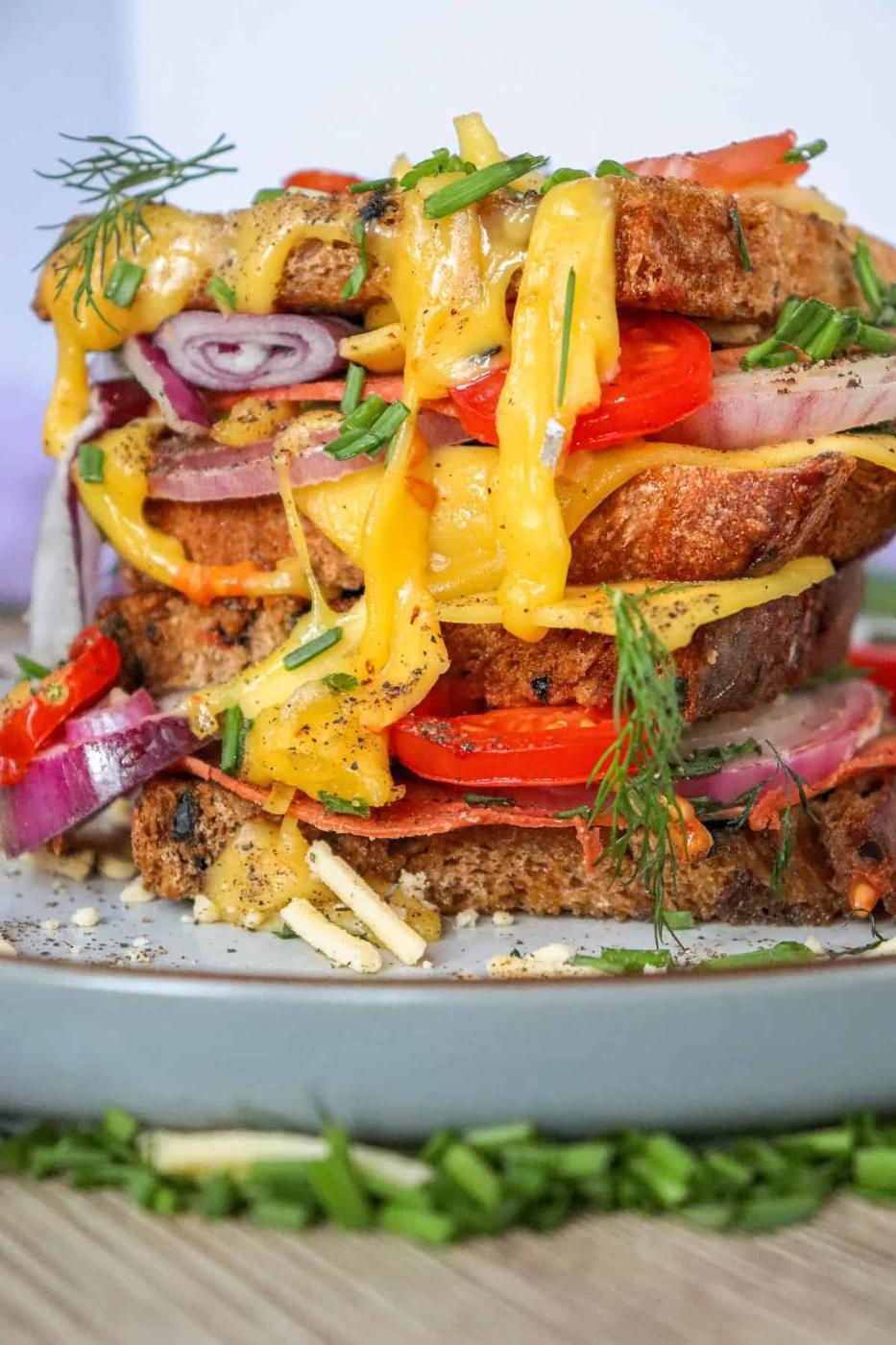 A stack of vegan melts with tomatoes and onions, perfect for the air fryer.