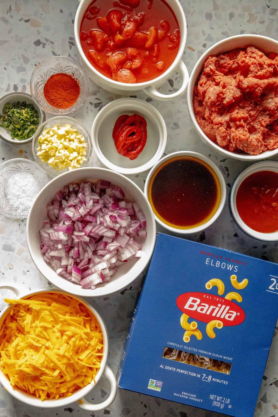 Various bowls of American macaroni goulash ingredients.