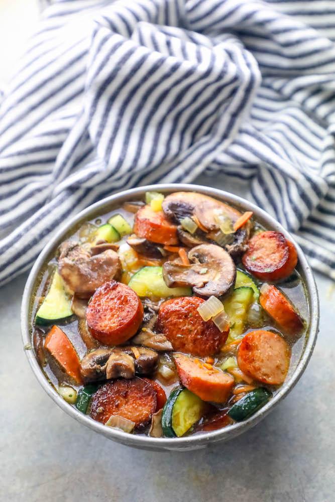 sausage, mushrooms, zucchini in a soup bowl