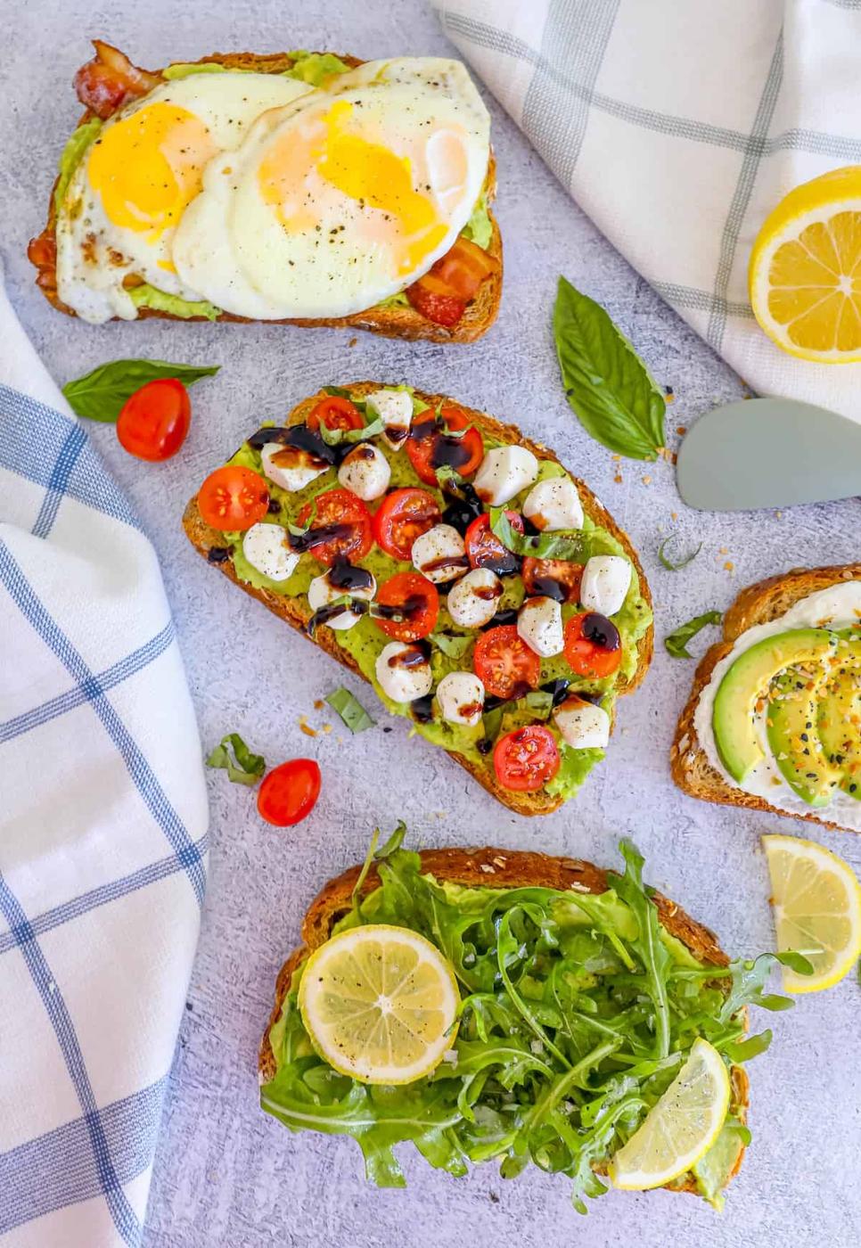 Four slices of toast with different toppings on them.