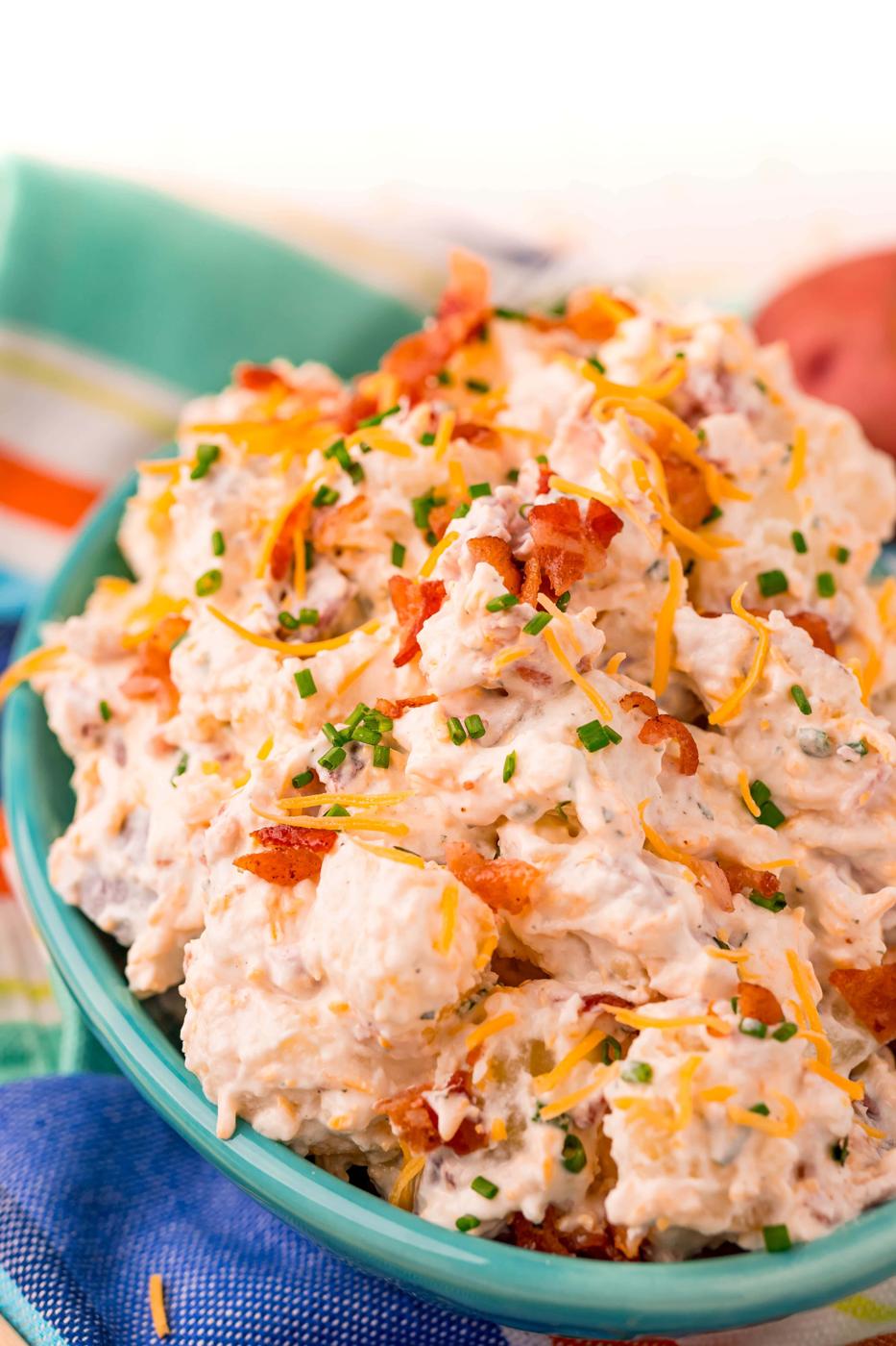 picture of ranch potato salad in a blue bowl on a colorful towel