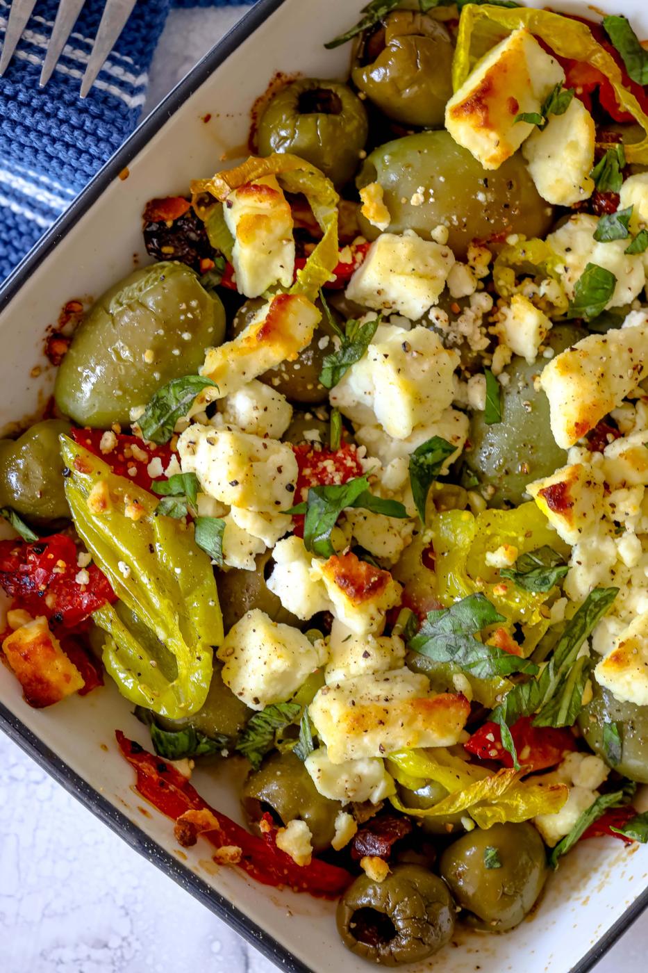 picture of baked olives and feta in a white glass dish