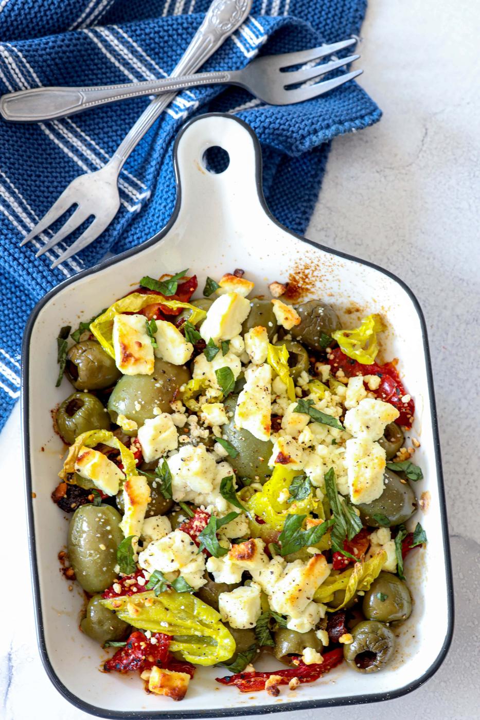 picture of baked olives and feta in a white glass dish
