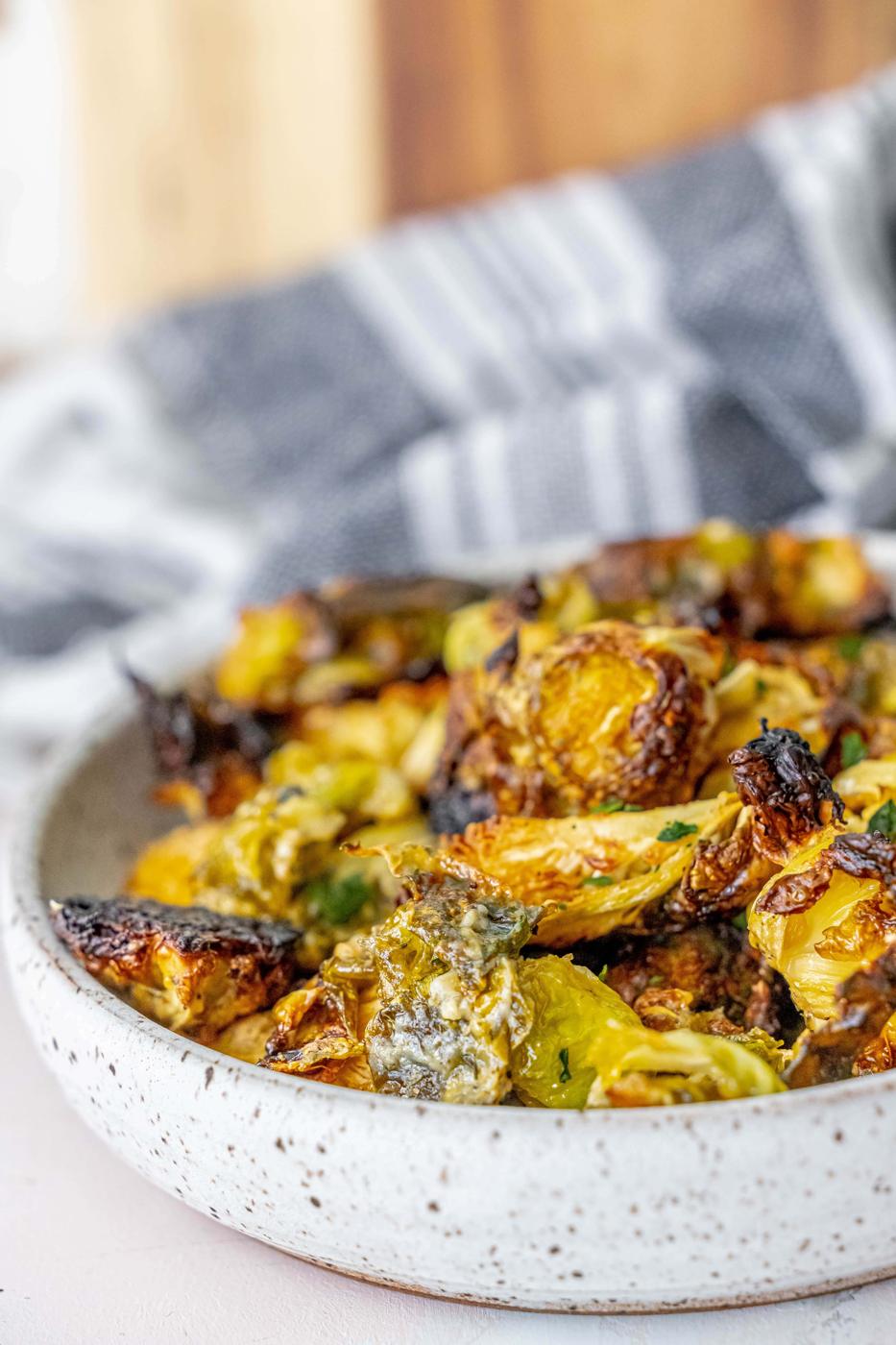 picture of caramelized ranch brussels sprouts in a white bowl