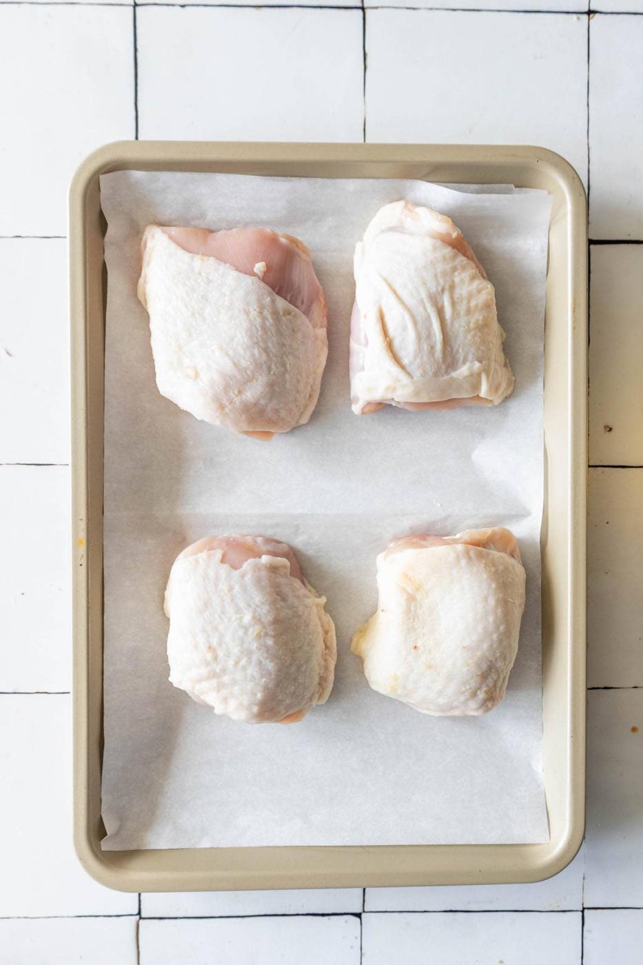 Baked chicken breasts on a tiled floor.