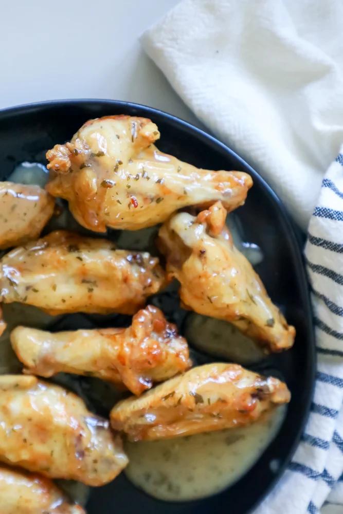 ranch chicken wings on a black plate up close