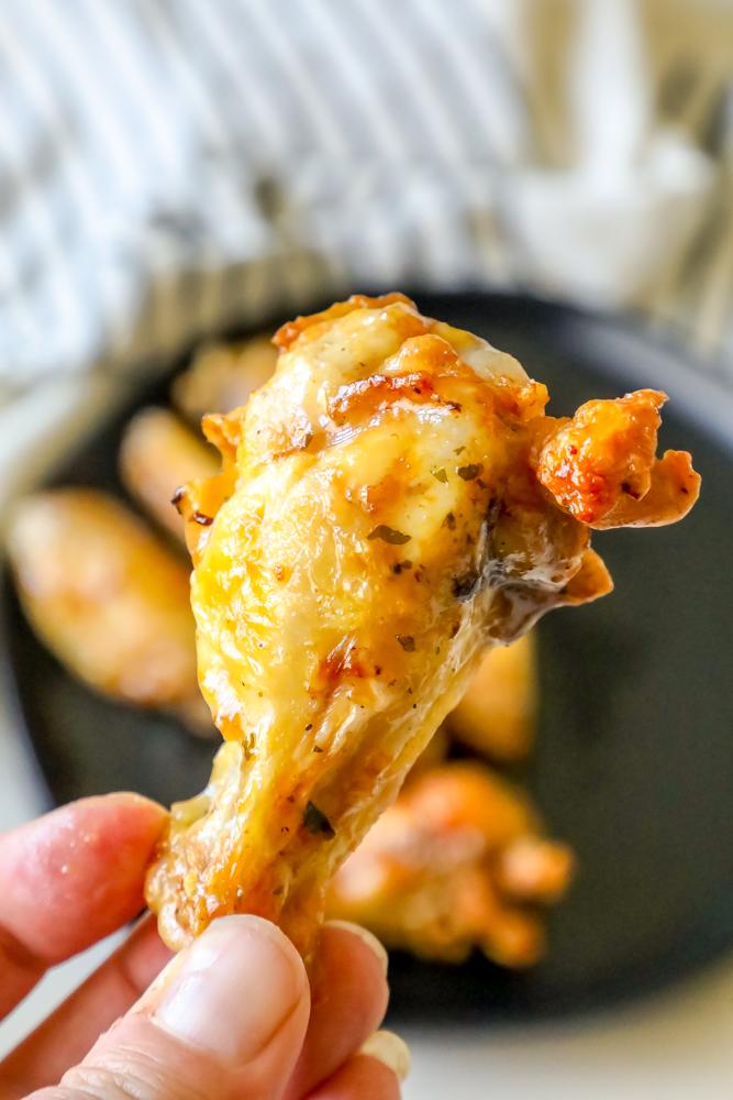 ranch chicken wings on a black plate up close one in front