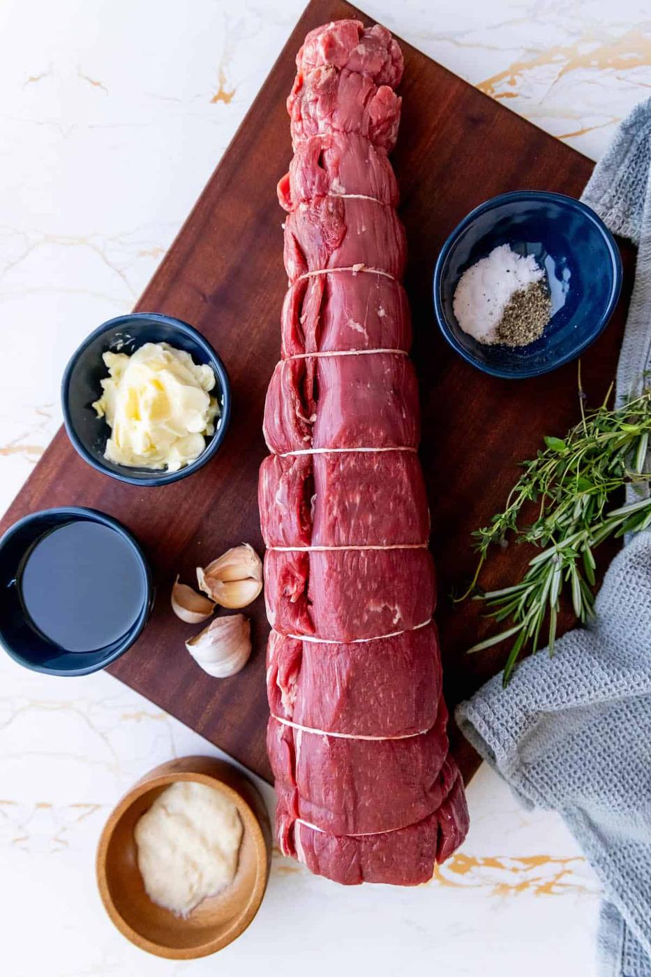Garlic herb beef tenderloin on a cutting board.
