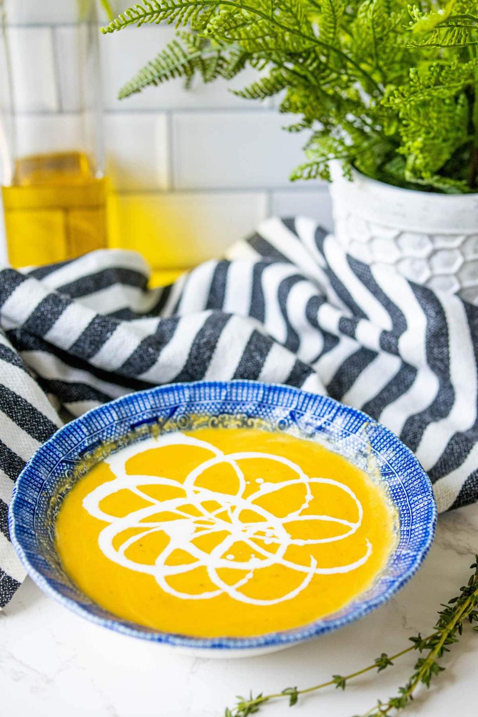 yellow soup with white cream decoration