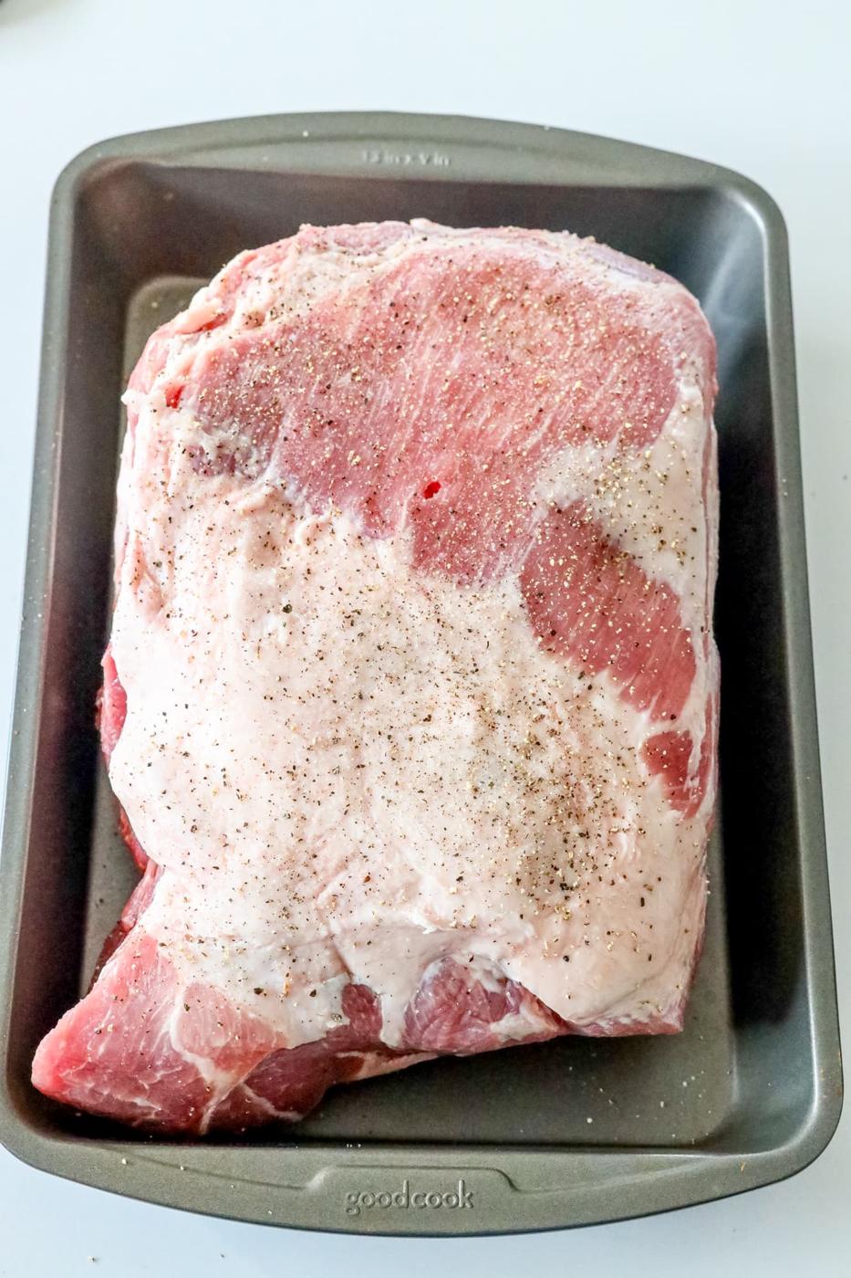 picture of seasoned raw pork shoulder in a pan