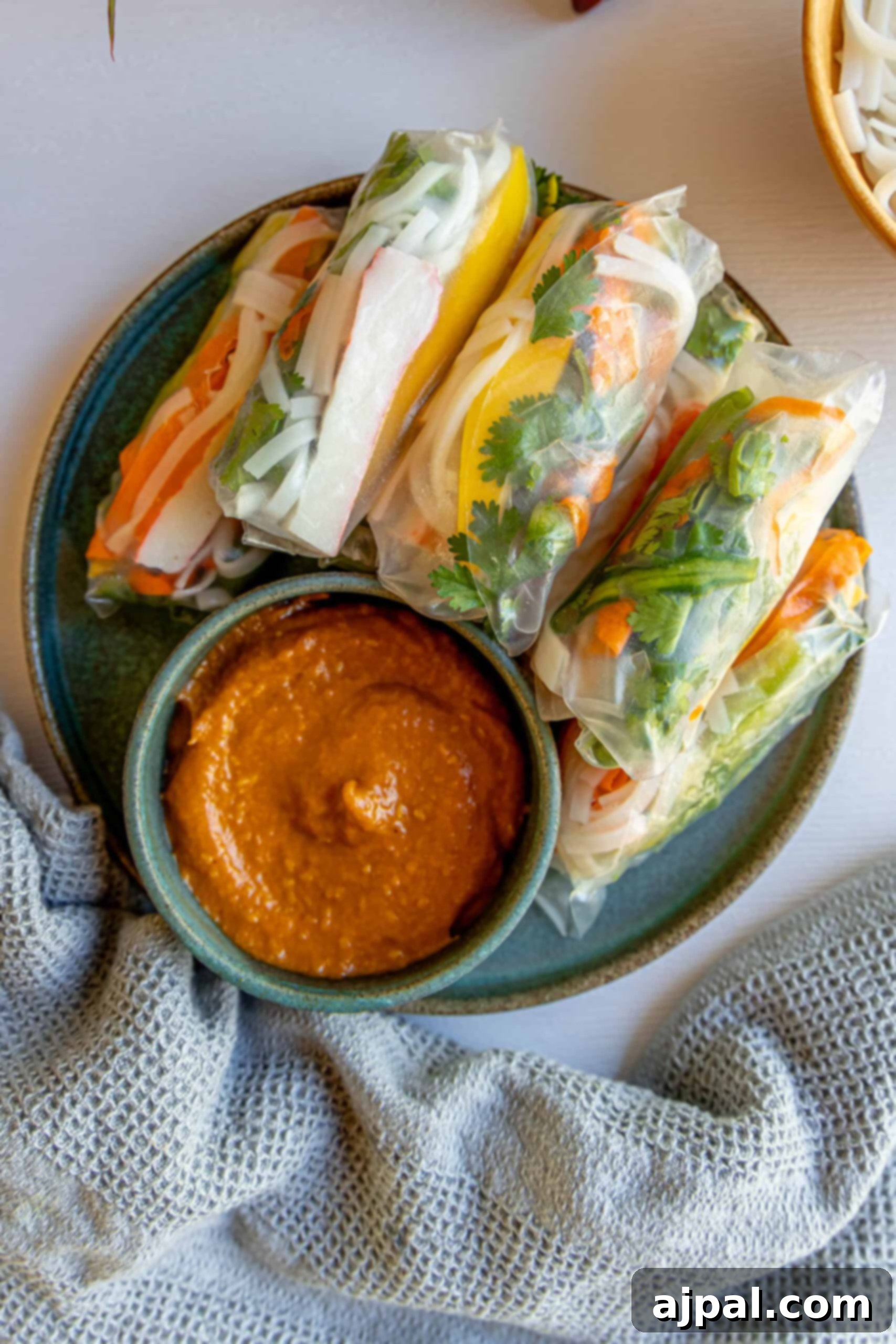 Plate of Vietnamese crab spring rolls served with dipping sauce.