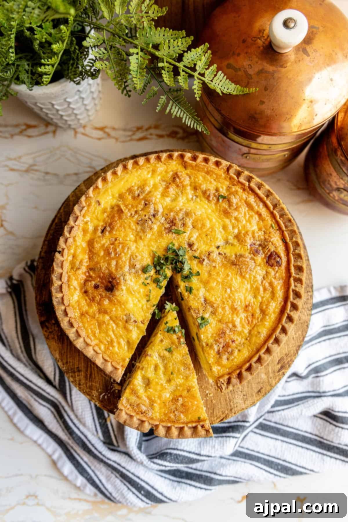 A delectable bacon and cheese quiche with a slice removed, showcasing its appealing texture and golden-brown crust.
