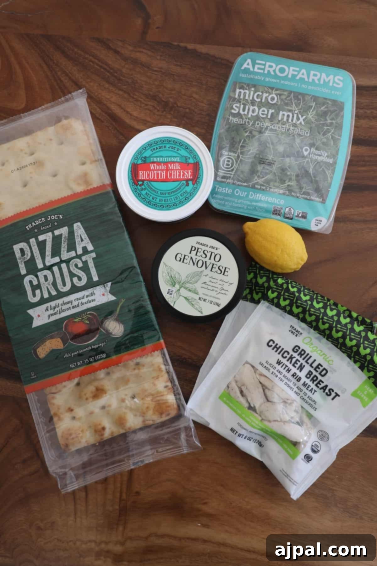 Artisan Pesto Chicken Flatbread 5 A selection of pizza crusts and crispy crackers arranged on a rustic wooden table.