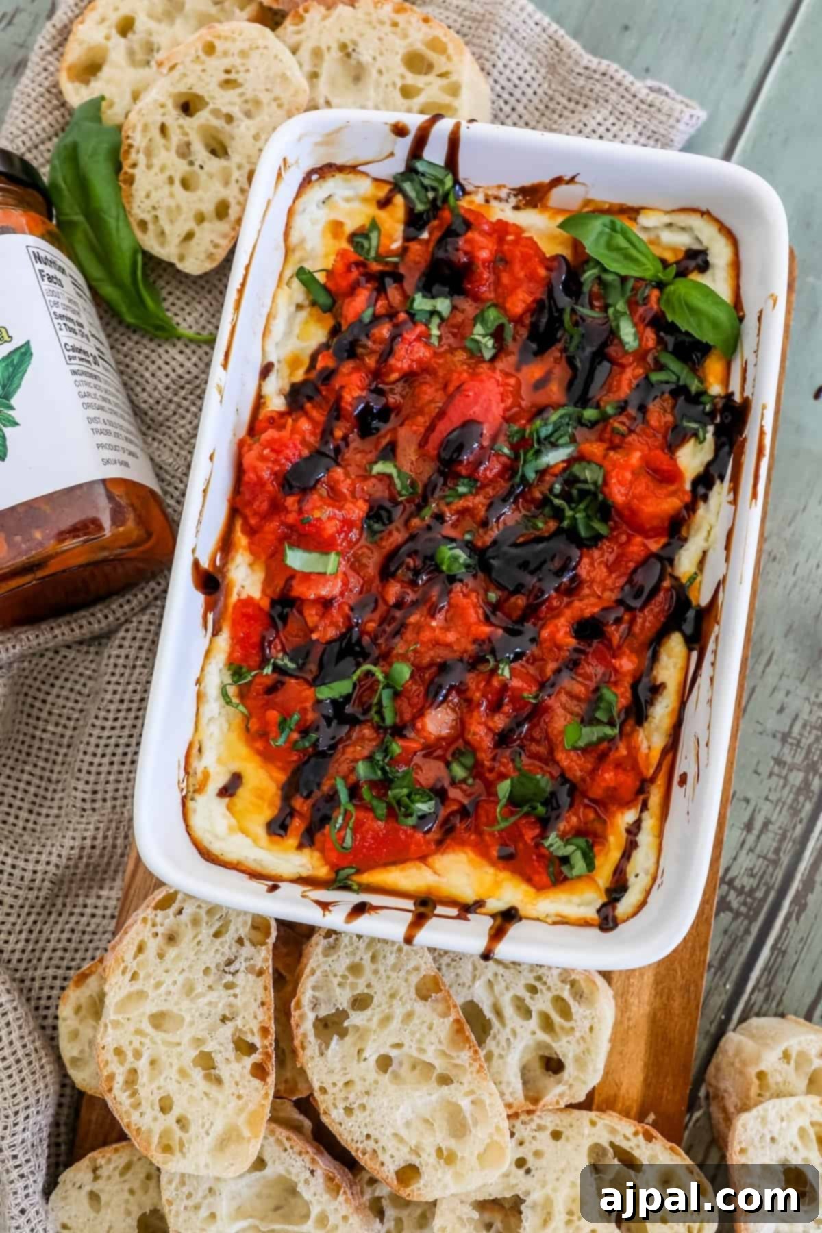 A mouth-watering dish of bruschetta dip, served with perfectly toasted bread on a rustic cutting board, ready to be enjoyed as a gourmet appetizer.