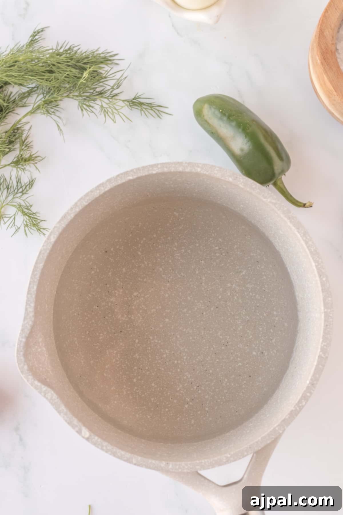 A cast iron skillet filled with spicy herbs.
