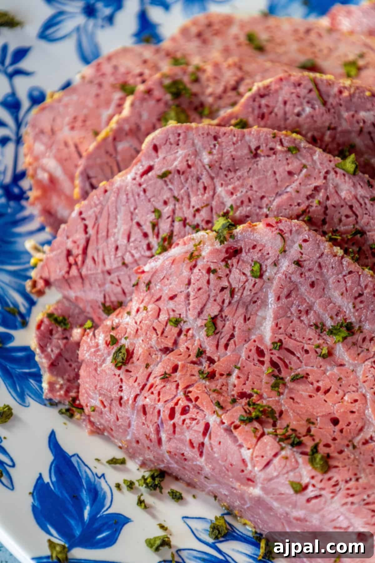 Perfectly Roasted Corned Beef 6 A beautifully presented plate of thinly sliced roasted corned beef, perfect for a festive meal.
